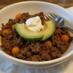 Finished quick keto ground beef meal with avocado and sour cream.