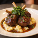 Delicious braised beef shanks served with mashed potatoes, a gourmet meal.