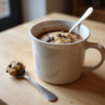 Freshly baked eggless chocolate chip mug cookie ready to eat.