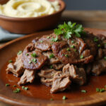 Shredded beef shoulder roast served with mashed potatoes.