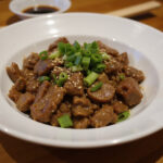 Finished keto beef mince stir-fry garnished with sesame seeds and green onions.