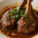 Deliciously slow-cooked beef shanks with gravy, showcasing their tenderness.