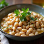Finished bowl of creamy butter beans garnished with parsley, ready to serve, from Best Way to Make Butter Beans Recipe.