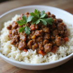 3 ingredient ground beef served over rice with parsley garnish.