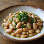 Finished butter beans, creamy and delicious, served as part of a hearty meal.