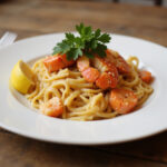 Delicious lobster pasta garnished with parsley and lemon, a perfect lobster pasta recipe.