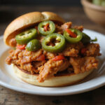 Perfect Mississippi Chicken sandwich served with pepperoncini peppers, ready to eat.