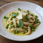 Delicious Pasta and Peas garnished with parmesan and olive oil.