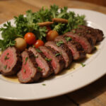 Juicy sliced beef striploin steak with herb garnish ready to serve.