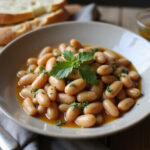 Finished Juicy Butter Beans served with parsley and crusty bread, a delicious and healthy dish.