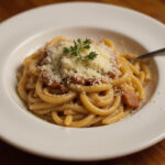 Delicious French Onion Pasta garnished with thyme and Gruyère cheese.