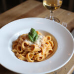 Plated Gigi Hadid Pasta with basil and Parmesan cheese.