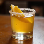Finished Juicy Lemon Drop Shot with a lemon twist garnish.