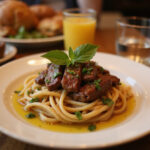 Finished plate of juicy steak pasta.