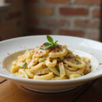 Delicious Boursin pasta with herbs and pepper flakes served in a bowl.