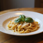 Finished Gigi Hadid pasta dish with basil and Parmesan, ready to eat.
