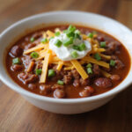 Ground beef chili made in Instant Pot, garnished and ready to eat.
