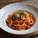 Delicious Instant Pot pasta with tomato sauce and basil, ready to eat.