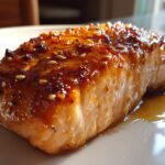 Close-up of maple glazed salmon fall, glistening with glaze and sprinkled with sesame seeds.