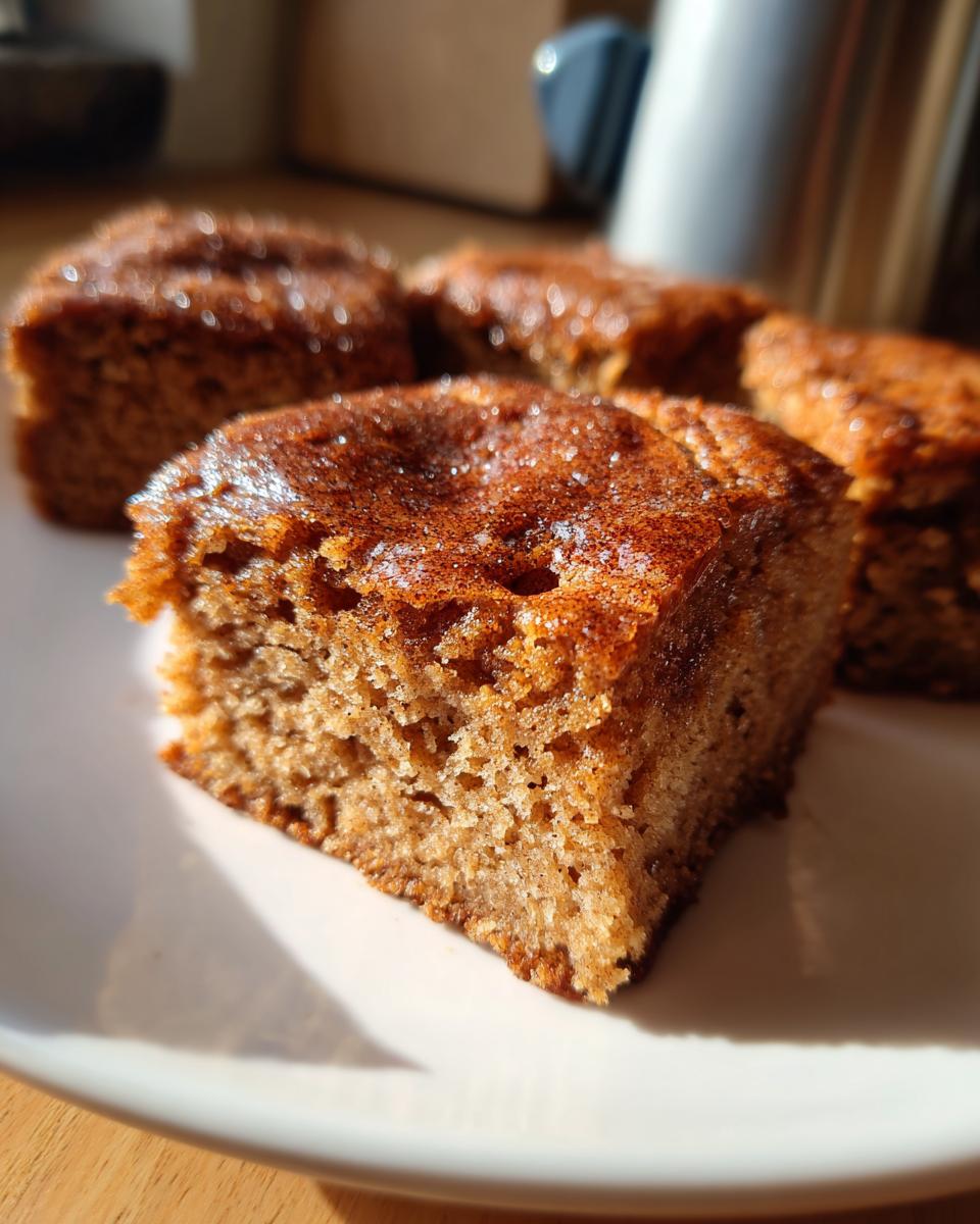 Close-up of Spiced Chai Snickerdoodle Blondies cut into squares and served on a white plate.