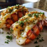 Two perfectly cooked lobster tails, glistening with butter and herbs, ready to be served as part of this lobster tail recipe.