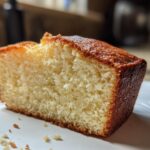 Close-up of a moist slice of vanilla cake with a golden-brown crust, part of a cake recipes article.