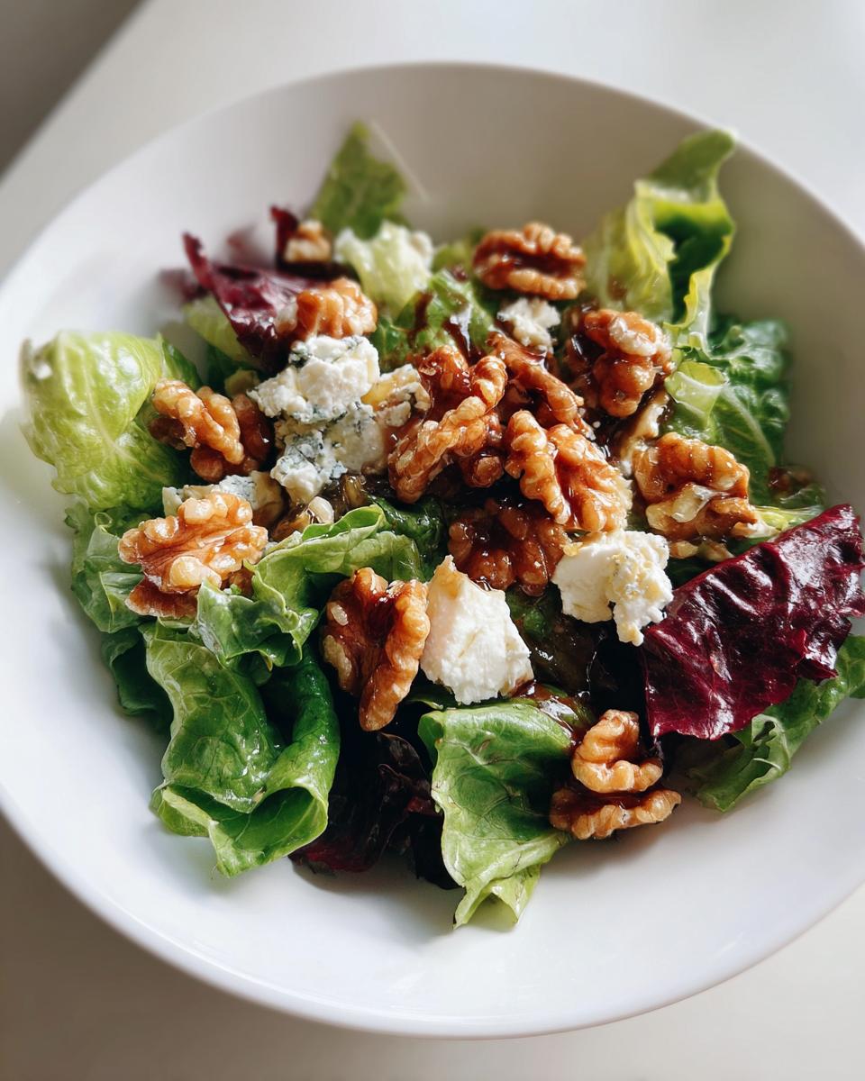 Bowl of salad with goat cheese, walnuts, and mixed greens