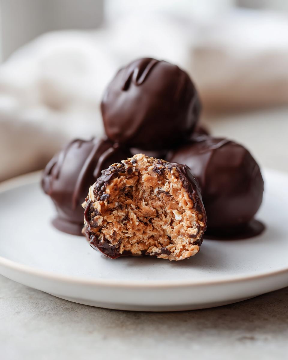 Close-up of chocolate peanut butter snacks with one cut open showing the inside texture.