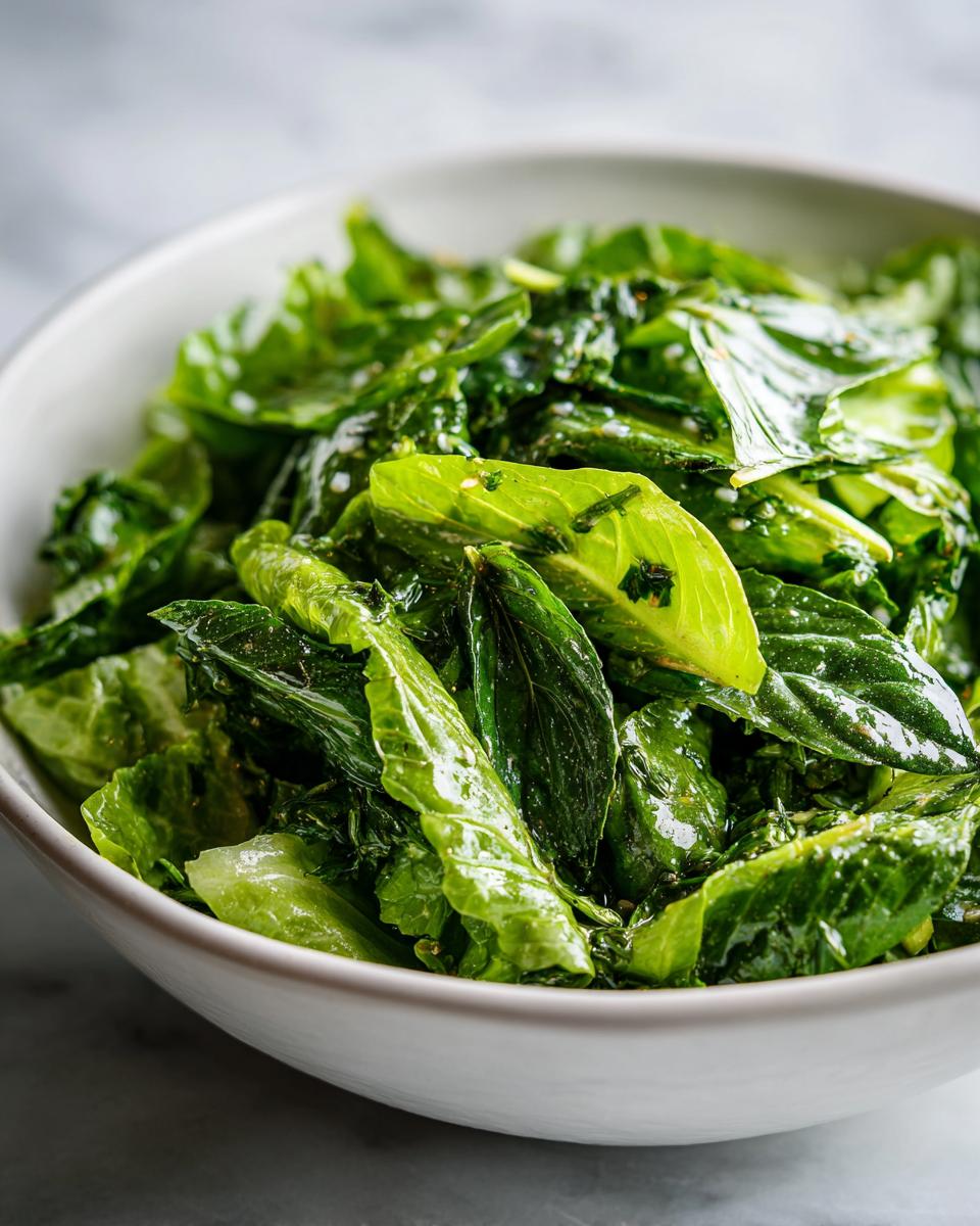 Close-up of a bowl filled with fresh green herbs and leafy greens for spring fresh herb recipes