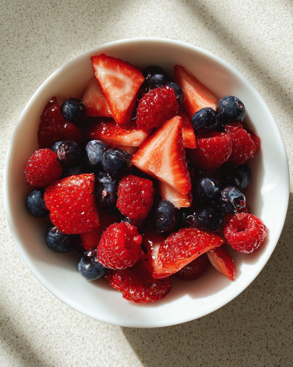 Bowl of fresh strawberries, raspberries, and blueberries for spring berry sweet treats