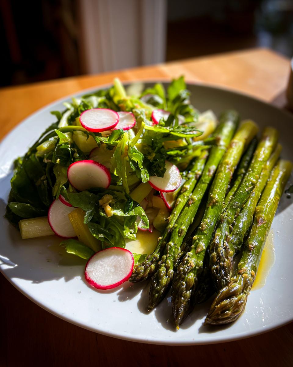 Plate of grilled asparagus and fresh radish salad with leafy greens for April brunch side dishes